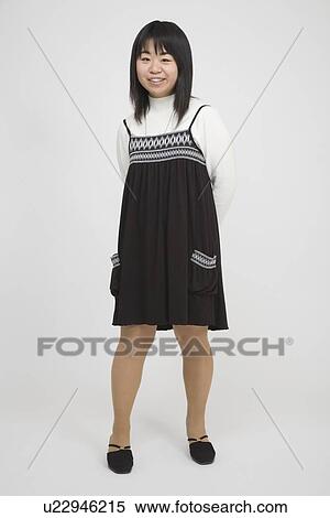 Stock Photography - Portrait of a young woman standing. Fotosearch