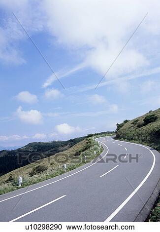 Stock Image - Curve road through mountain. Fotosearch