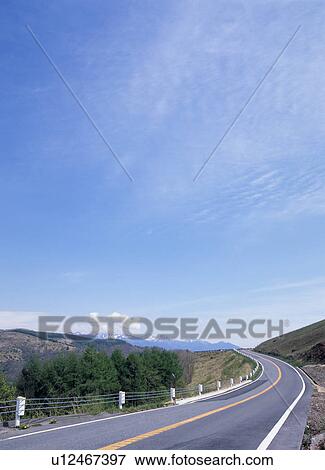Stock Photo - Left curve road through mountain. Fotosearch