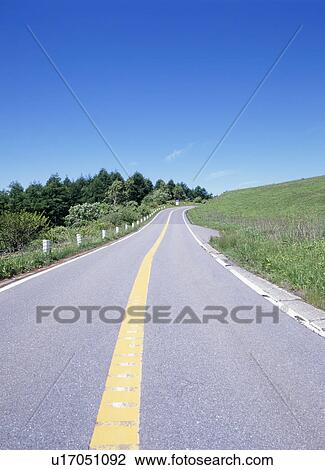 Stock Image - Road through mountain. Fotosearch