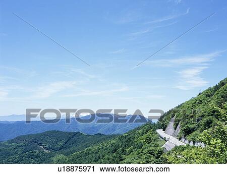 Stock Image - Road through mountain. Fotosearch