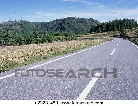 Stock Image - Road through mountain. Fotosearch
