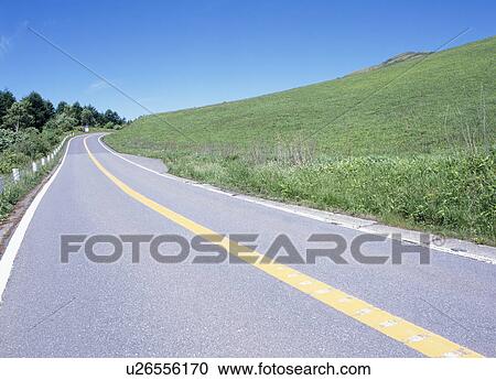 Stock Image - Road through mountain. Fotosearch