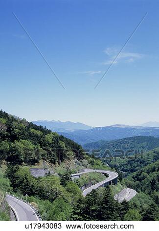 Stock Image - Winding road through mountain. Fotosearch