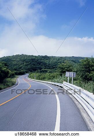 Stock Photo - Winding road through mountain. Fotosearch