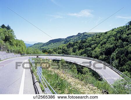 Stock Photograph - Winding road through mountain. Fotosearch