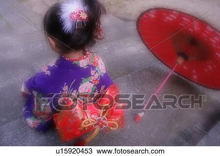 Stock Image - A girl wearing kimono. Fotosearch