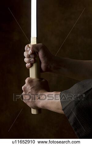 Japanese man holding sword View Large Photo Image Stock Image - Japanese man holding sword. Fotosearch