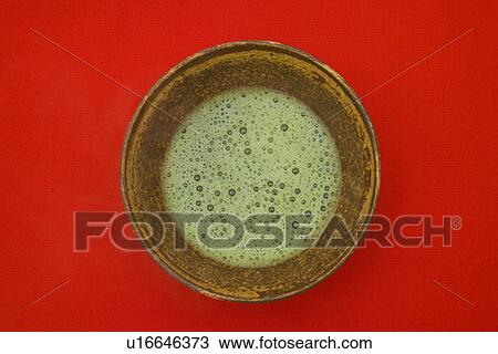 Stock Image - Matcha tea in tea bowl. Fotosearch