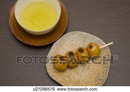 Stock Photo - Skewered dumpling with Japanese green tea. Fotosearch