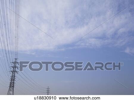 Stock Image - Cirrostratus clouds and steel tower. Fotosearch