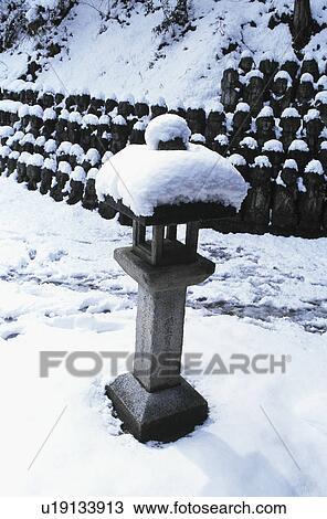 Stock Image - Snow and stone lantern. Fotosearch