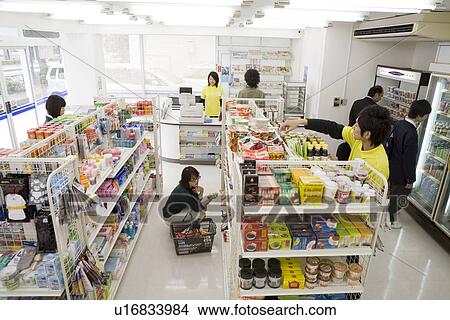 Picture - Clerk and customer at convenience store. Fotosearch