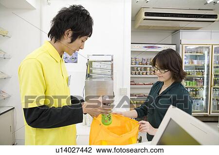 Clerk and customer at convenience store View Large Photo Image Stock Image - Clerk and customer at convenience store. Fotosearch