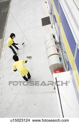 Convenience store clerk cleaning up store View Large Photo Image Picture - Convenience store clerk cleaning up store. Fotosearch