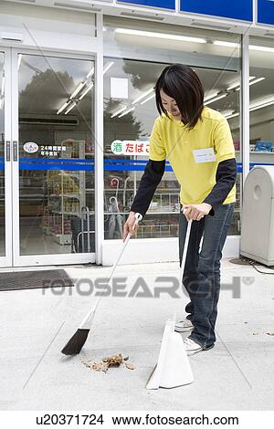 Convenience store clerk cleaning up store View Large Photo Image Picture - Convenience store clerk cleaning up store. Fotosearch