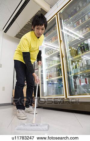 Stock Photo - Convenience store clerk cleaning up store. Fotosearch