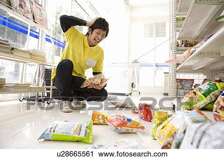 Stock Image - Convenience store clerk making mistake. Fotosearch