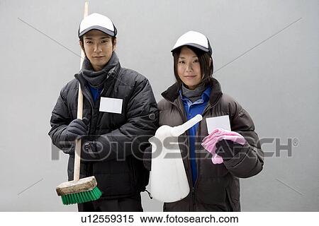 Stock Photography - Gas station clerk holding cleaning goods. Fotosearch