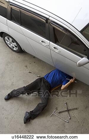 Stock Image - Gas station clerk maintaining car. Fotosearch