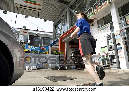Stock Image - Gas station clerk running. Fotosearch