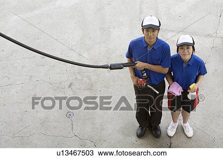 Stock Image - Gas station clerk standing. Fotosearch