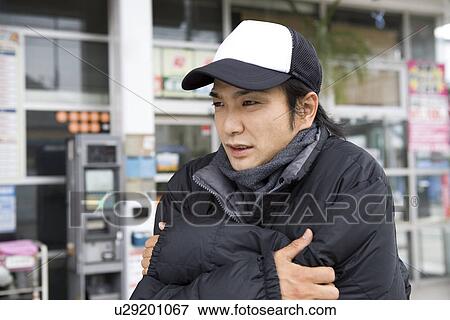 Stock Photo - Gas station clerk wearing down jacket. Fotosearch