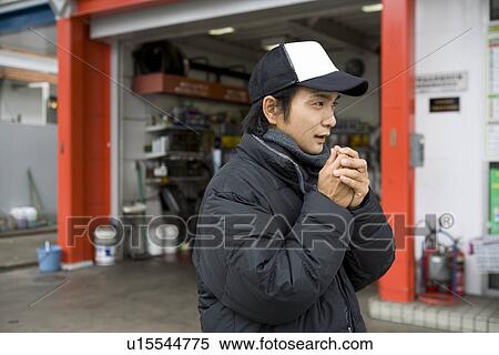 Stock Photography - Gas station clerk wearing down jacket. Fotosearch