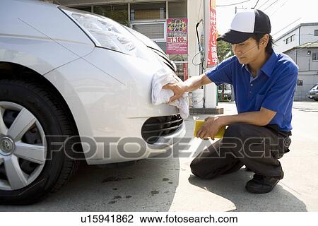Gas station clerk wiping car View Large Photo Image Stock Image - Gas station clerk wiping car. Fotosearch