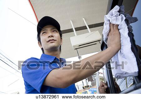 Gas station clerk wiping car window View Large Photo Image Stock Image - Gas station clerk wiping car window. Fotosearch