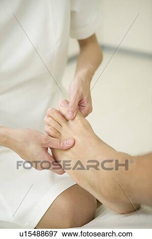 Stock Photo - Foot massage. Fotosearch