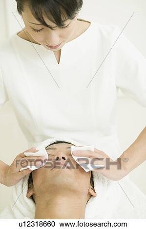 Massage therapist applying facial treatment View Large Photo Image Stock Image - Massage therapist applying facial treatment. Fotosearch