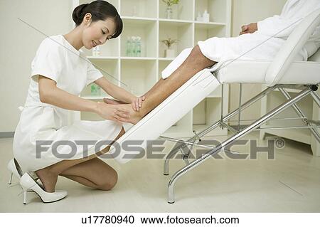 Massage therapist applying foot massage View Large Photo Image Stock Image - Massage therapist applying foot massage. Fotosearch