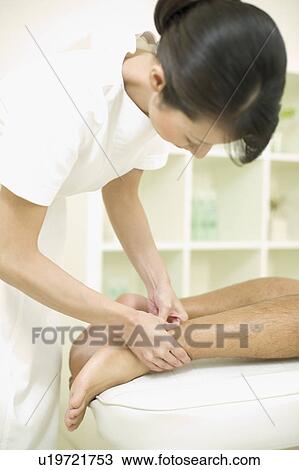 Massage therapist applying foot massage View Large Photo Image Stock Image - Massage therapist applying foot massage. Fotosearch
