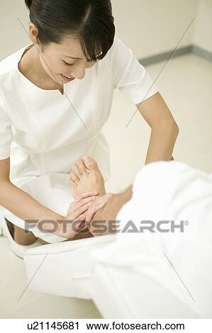 Massage therapist applying foot massage View Large Photo Image Stock Image - Massage therapist applying foot massage. Fotosearch