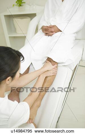Massage therapist applying foot massage View Large Photo Image Stock Photography - Massage therapist applying foot massage. Fotosearch