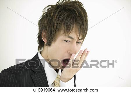 Young businessman checking his breath View Large Photo Image Picture - Young businessman checking his breath. Fotosearch