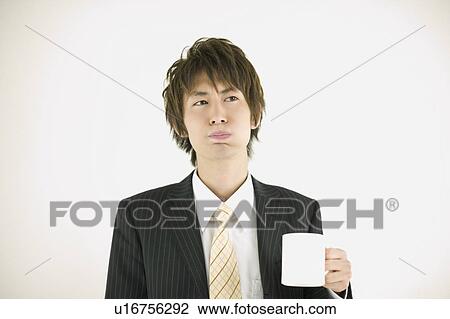 Stock Image - Young businessman gargling. Fotosearch