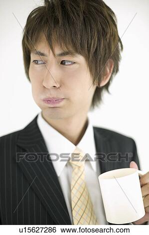 Stock Photograph - Young businessman gargling. Fotosearch