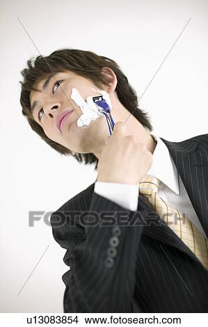 Picture - Young businessman shaving. Fotosearch