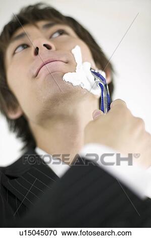 Young businessman shaving View Large Photo Image Stock Image - Young businessman shaving. Fotosearch