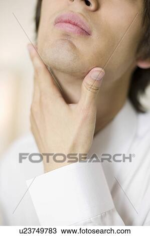 Young businessman worrying about his beards View Large Photo Image Stock Image - Young businessman worrying about his beards. Fotosearch