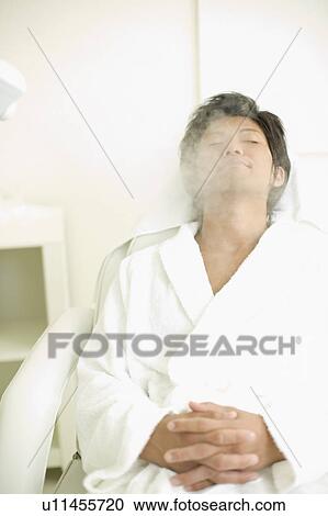 Young man receiving esthetic facial steam View Large Photo Image Stock Image - Young man receiving esthetic facial steam. Fotosearch