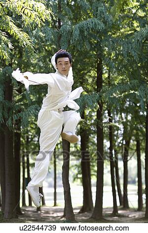 China, man practicing martial arts in park View Large Photo Image Stock Photo - China, man practicing martial arts in park. Fotosearch