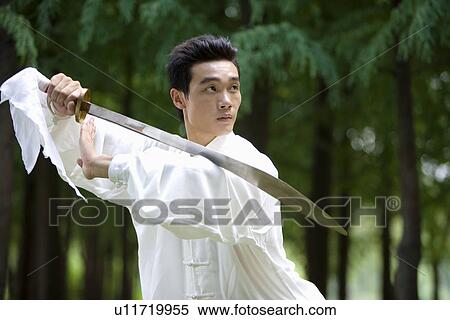 Stock Photography - Man practicing martial arts with swords. Fotosearch