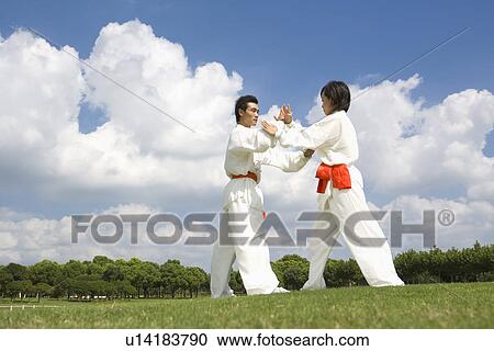 Young man and woman doing kung-fu moves View Large Photo Image Stock Image - Young man and woman doing kung-fu moves. Fotosearch
