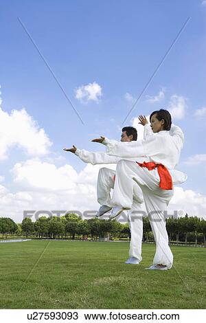 Young man and woman doing the same kung-fu moves View Large Photo Image Stock Image - Young man and woman doing the same kung-fu moves. Fotosearch