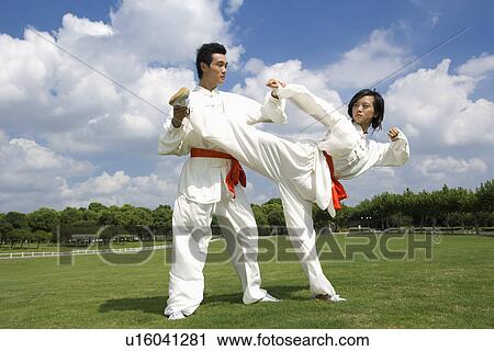Young man and woman practicing martial arts View Large Photo Image Stock Image - Young man and woman practicing martial arts. Fotosearch