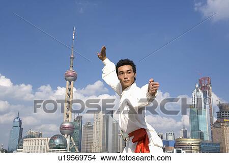 Picture - Young man doing martial arts on the Bund. Fotosearch