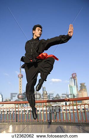 Young man doing martial arts on the Bund View Large Photo Image Stock Image - Young man doing martial arts on the Bund. Fotosearch